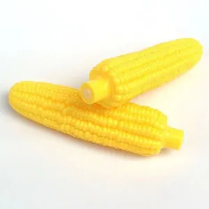 Close-up of yellow squeaky corn dog toy showing textured surface for teeth cleaning