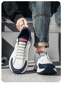 Close-up of men's breathable outdoor sneakers with navy and red color-blocking.