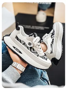 Detail of breathable designer men's sneakers with ethnic patchwork and thick sole