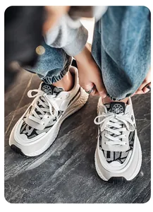 Detailed view of men's breathable color-blocked athletic sneakers on stone floor