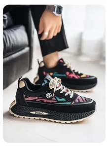 Detailed close-up side view of men's breathable ethnic patchwork sneakers with chunky soles