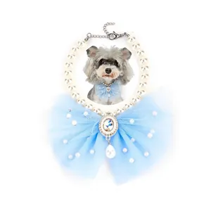 Detail view of pet pearl necklace with large light blue mesh bow and crystal pendant