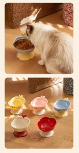 Detail view of apple-shaped pet bowls in various colors on a wooden floor.