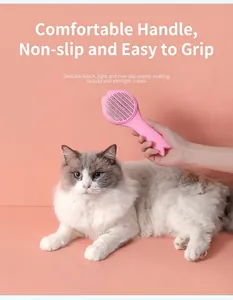 Detailed view of a pink cat self-cleaning brush being used on a long-haired cat.