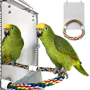 Close-up detail of acrylic bird mirror featuring a colorful cotton rope perch for parrots