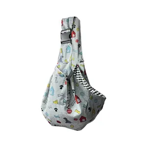 Detail view of a grey adjustable pet carrier sling bag with cute cartoon puppy print