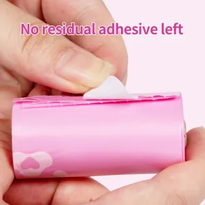 Detail of pink degradable dog poop bag roll showing no adhesive residue after peeling.