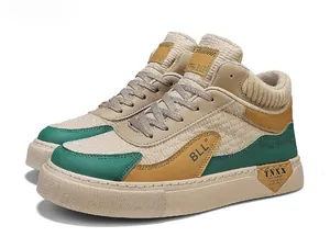 Macro view of mid-top color-block sneakers featuring unique BLL and TNXX design.