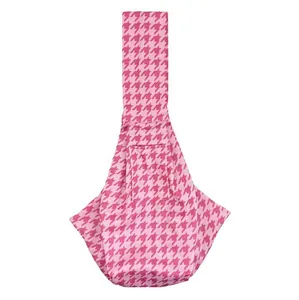 Detailed view of the pink houndstooth pattern on this foldable and portable pet carrier sling bag
