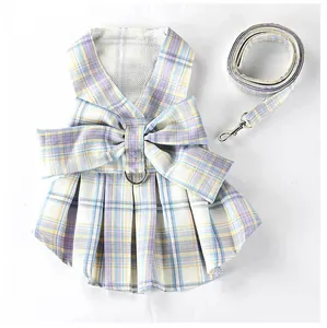 Detailed view of a purple and yellow plaid pet harness dress with matching walking leash.