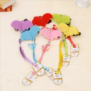 Close-up of colorful angel wing pet harness and leash sets on plush background