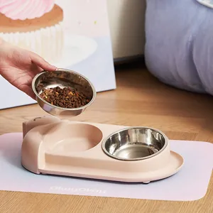 Pink tilted double pet bowl with stainless steel inserts and non-slip mat for neck protection