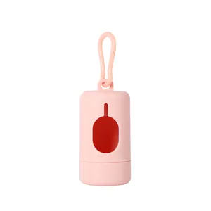 Detail view of a pink portable pet waste bag dispenser with an integrated clip.
