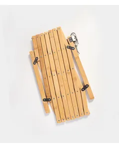 Macro view of a portable folding wooden accordion pet gate fence for home safety