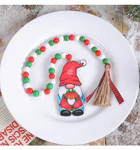 Detailed view of Christmas gnome wooden hanging ornament with colorful beads and tassel