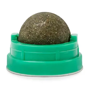 Close-up of a rotating catnip ball toy with a green base for feline entertainment