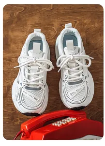 Vista superior detallada de zapatillas blancas de malla en una mesa de madera rústica