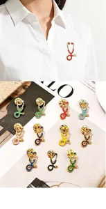 Detailed view showing multiple colorful stethoscope enamel pins on a white background