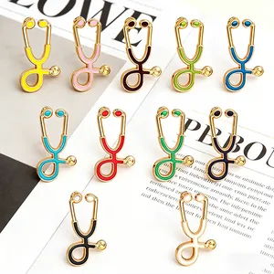 Colorful cartoon stethoscope enamel brooches set for medical staff displayed on magazine