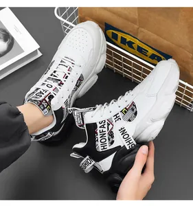 Close-up of mens white mid-top chunky sneakers featuring decorative HIONFASH straps.