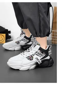 Close-up of white and black high-top basketball shoes featuring bold fashion print design.