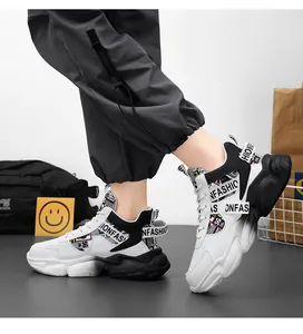 On-feet view of white and black high-top sneakers with fashion prints and platform sole