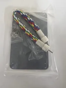 Detail view of bird toy package featuring colorful cotton rope perch and acrylic mirror components.