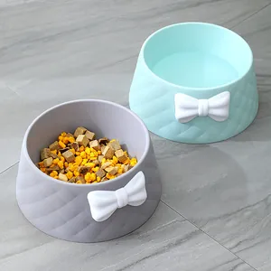 Two macaron colored pet bowls featuring diamond quilted texture and cute white bows