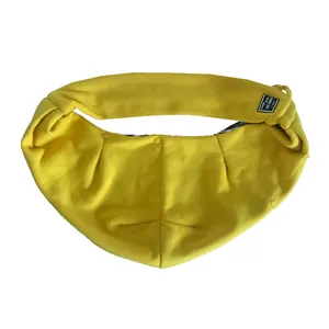 Detail macro view of soft yellow cotton pet sling carrier for cats and small dogs