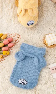 Close-up of soft plush pet hoodies featuring cute rabbit ears and cartoon patches