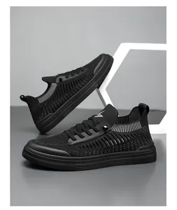 Detail view of black fly-knit sneakers with breathable mesh and modern sporty design.