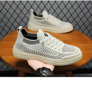 Close-up of beige flyknit men's sneakers featuring breathable mesh and thick sole.