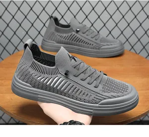Close-up of grey flyknit casual sports shoes featuring a breathable mesh pattern design