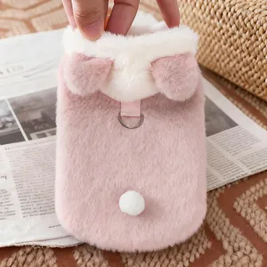 Close-up view of a pink plush pet vest featuring cute bear ears and a leash D-ring.