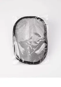 Detail view of pet hair removal glove in transparent packaging, grey mesh design.