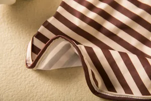 Macro view showing the durable stitching and elastic striped fabric of this dog base shirt.