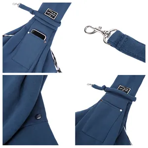 Detail view of blue breathable pet sling carrier showing pockets and safety metal clip.