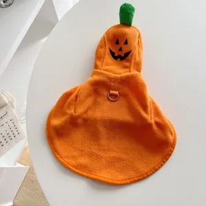 Detail view of orange fleece Halloween pumpkin pet cape with Jack-o'-lantern face and D-ring