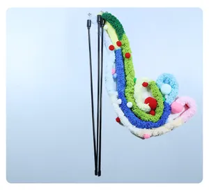 Detailed view of the colorful plush attachment of the cat teaser wand with small pom-poms