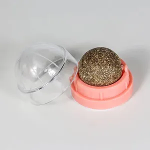 Close-up of a rotating natural catnip ball toy with pink base and clear protective lid