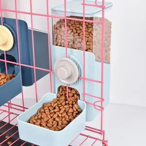 Detail view of a blue gravity pet feeder attached to a pink wire cage with kibble