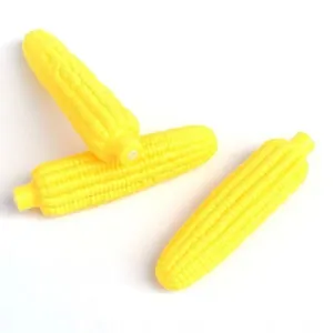 Set of three yellow corn-shaped squeaky vinyl chew toys for small dogs on a white background