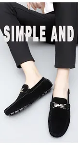Detailed view of men's black suede loafers with gold metal buckle decoration
