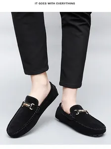 Detail view of black suede loafers for men featuring a stylish gold metal buckle decoration