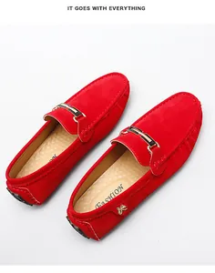 Detailed view of red suede loafers for men with decorative metallic buckle
