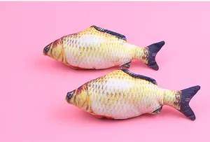 Realistic plush fish cat toys on a pink background showing detailed scale and fin textures