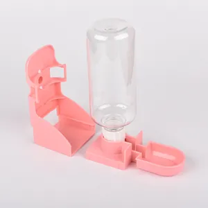 Pink pet water dispenser for cats and dogs with a clear bottle and wall-mount bracket.