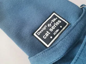 Close-up detail of the durable blue fabric and designer patch on pet carrier bag
