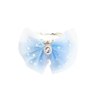Close-up of elegant light blue tulle bow pet collar with pearls and rhinestone pendant