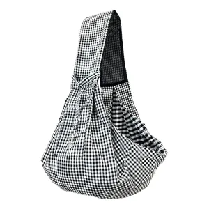 Detailed view of breathable gingham pet sling carrier for cats and small dogs in black
